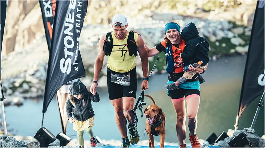 Trail runners on the final climb with their children and dog